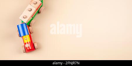 Wooden toy train with multi colored blocks on pastel beige background. Top view Stock Photo