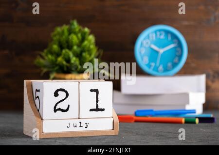 July 21st. July 21 wooden cube calendar with blur objects on background. Stock Photo