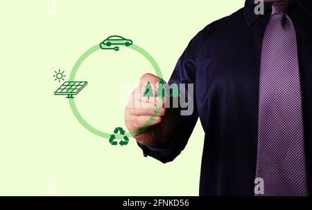 Businessman drawing on whiteboard. Anti global warming corporate measures. Stock Photo