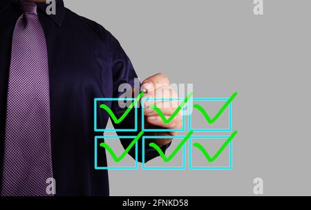 Businessman ticking off all boxes on a checklist. Stock Photo