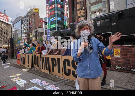 Tokyo, Japan. 17th May, 2021. Protester speaks during an anti Tokyo 2020 Olympic Games Rally in Ginza district.Around 30 to 40 protesters took to the streets calling for the cancelation of the Olympic Games this summer. They were accompanied by the same number of police officers. Protesters went from Shinbashi station through the Ginza district to the Head Office of the Organization Committee for the Games. Credit: SOPA Images Limited/Alamy Live News Stock Photo
