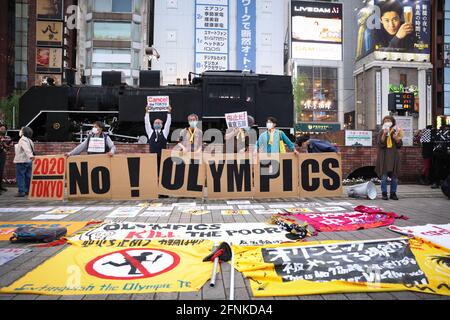 Tokyo, Japan. 17th May, 2021. Protesters express their opinions with placards, and banners against the Tokyo 2020 Olympic Games.Around 30 to 40 protesters took to the streets calling for the cancelation of the Olympic Games this summer. They were accompanied by the same number of police officers. Protesters went from Shinbashi station through the Ginza district to the Head Office of the Organization Committee for the Games. Credit: SOPA Images Limited/Alamy Live News Stock Photo