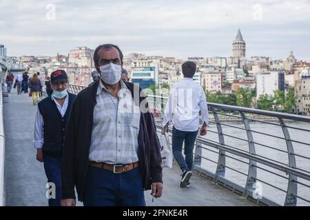 Istanbul, Turkey. 17th May, 2021. People seen walking at Halic Metro Bridge.After 3 weeks of lock down, citizens threw themselves into the street. In Istanbul, both vehicle and pedestrian traffic was intense. Turkey emerged from a 17-day-long lockdown on May 17 and moved to a period of gradual lifting that will last until June 1. (Photo by Ibrahim Oner/SOPA Images/Sipa USA) Credit: Sipa USA/Alamy Live News Stock Photo