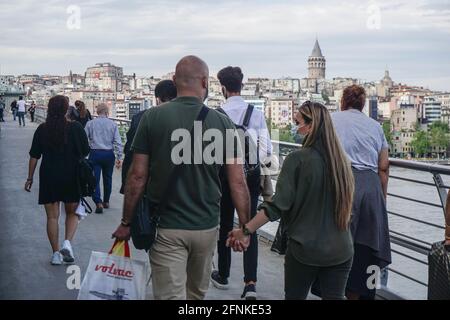 Istanbul, Turkey. 17th May, 2021. People seen walking at Halic Metro Bridge.After 3 weeks of lock down, citizens threw themselves into the street. In Istanbul, both vehicle and pedestrian traffic was intense. Turkey emerged from a 17-day-long lockdown on May 17 and moved to a period of gradual lifting that will last until June 1. (Photo by Ibrahim Oner/SOPA Images/Sipa USA) Credit: Sipa USA/Alamy Live News Stock Photo