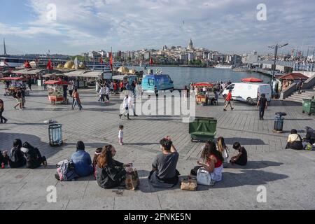 Istanbul, Turkey. 17th May, 2021. People seen sitting at Eminonu district.After 3 weeks of lock down, citizens threw themselves into the street. In Istanbul, both vehicle and pedestrian traffic was intense. Turkey emerged from a 17-day-long lockdown on May 17 and moved to a period of gradual lifting that will last until June 1. (Photo by Ibrahim Oner/SOPA Images/Sipa USA) Credit: Sipa USA/Alamy Live News Stock Photo