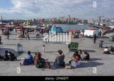 Istanbul, Istanbul Province, Turkey. 17th May, 2021. People seen sitting at Eminonu district.After 3 weeks of lock down, citizens threw themselves into the street. In Istanbul, both vehicle and pedestrian traffic was intense. Turkey emerged from a 17-day-long lockdown on May 17 and moved to a period of gradual lifting that will last until June 1. Credit: Ibrahim Oner/SOPA Images/ZUMA Wire/Alamy Live News Stock Photo