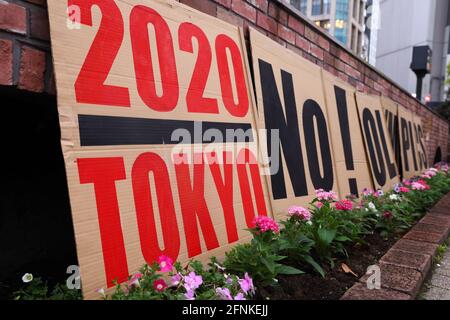 Tokyo, Japan. 17th May, 2021. '2020 Tokyo No!' seen during an anti Tokyo 2020 Olympic Games Rally in Ginza district.Around 30 to 40 protesters took to the streets calling for the cancelation of the Olympic Games this summer. They were accompanied by the same number of police officers. Protesters went from Shinbashi station through the Ginza district to the Head Office of the Organization Committee for the Games. (Photo by Stanislav Kogiku/SOPA Images/Sipa USA) Credit: Sipa USA/Alamy Live News Stock Photo