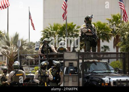 Los Angeles, California, USA - May 15, 2021: Los Angeles County Sheriff's Department officers in full tactical gear deploy to guard against violence a Stock Photo