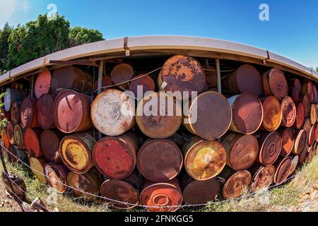 A wall made from rusted drums photographed with a fisheye lens Stock Photo