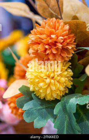 Paper tied blooming yellow big chrysanthemum close-up, artificial flower Stock Photo