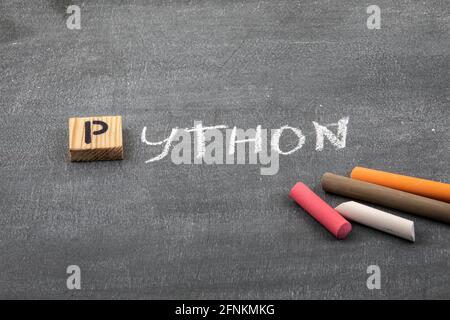Riga, Latvia - May 10 ,2021: Python code and programming language concept. Colored chalk pieces on a black chalk board. Stock Photo