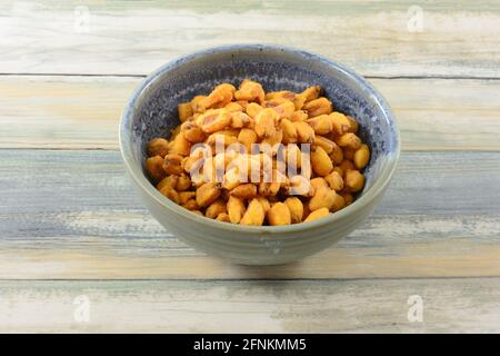 Turkish roasted paprika corn nuts in ceramic snack bowl on table Stock Photo