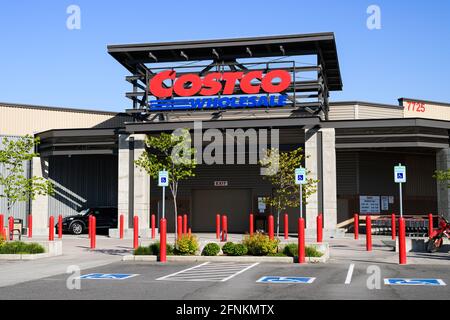 Redmond, WA, USA - May 16, 2021; Entrance to Costco Wholesale store with sign before opening hours with no people in Redmond, Washington State, USA Stock Photo