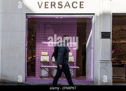 London, UK. 17th May, 2021. A man wearing face mask passes Versace luxury shop. The Prime Minister announced that England can proceed to Stage Three on May 17, 2021. Most shops can reopen including indoor. Credit: SOPA Images Limited/Alamy Live News Stock Photo