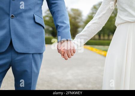 Bride and groom holding hands Stock Photo
