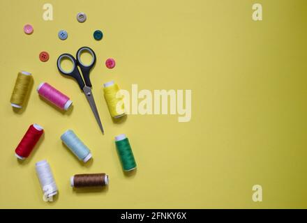 High angle view of sewing items on yellow background Stock Photo
