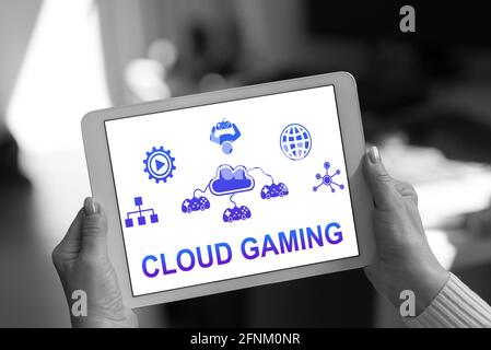 Cloud gaming concept shown on a tablet held by a woman Stock Photo
