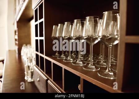 Empty wine glasses in row. Shallow depth of field. Focus on foreground Stock Photo