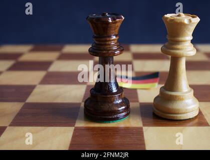 two queens standing against german flag Stock Photo
