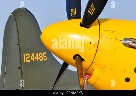 Yellow nose of a North American P-51D Mustang fighter plane with propeller detail, and tail of Boeing B-17 Flying Fortress. Second World War planes Stock Photo