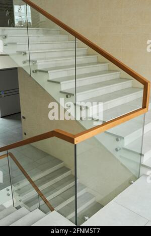 Image of stairs with glass railing in modern office building Stock Photo