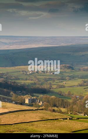 Scenic rural view of Wharfedale (wide green valley, rolling hills, high upland fells & moors, sunlit Barden Tower ruins) - Yorkshire Dales England, UK Stock Photo