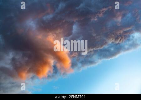 Dramatic rain clouds background. Colorful clouds on the sunset sky Stock Photo