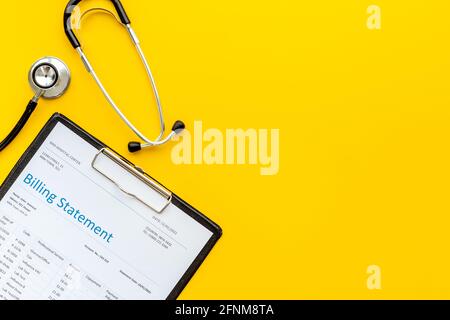 Medical billing statement with stethoscope. Top view Stock Photo