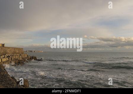 Coastal area with rocks on background of the wavy sea in Cadiz, Andalucia, Spain Stock Photo