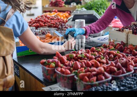 Woman making contactless payment with credit card on farmers market Stock Photo