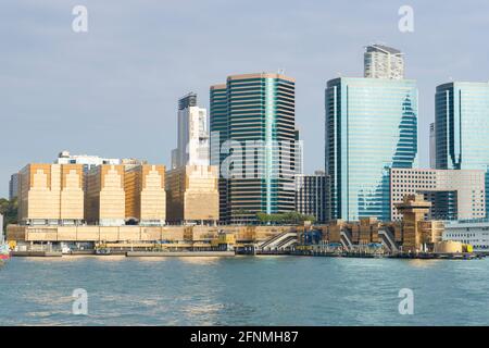 China Hong Kong City and China Ferry Terminal. The Golden Colored Commercial Buildings located in Tsim Sha Tsui, Kowloon, Hong Kong Stock Photo