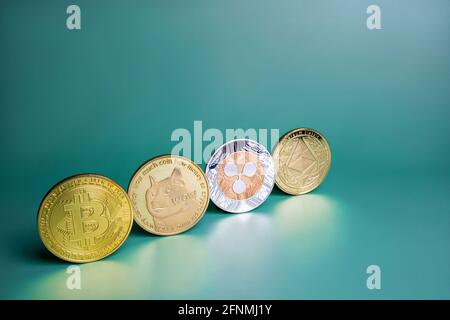 Bitcoin, Ripple XRP, Dogecoin, Ethereum crypto coins row on green background. Popular cryptocurrencies banner Stock Photo