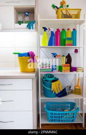 Cleaning supplies and tools on shelves and cabinets in pantry room Stock Photo