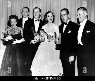 BETTE DAVIS who accepted the Best Supporting Actress Oscar for Kim Hunter in A Streetcar Named Desire from GEORGE SANDERS (at back) KARL MALDEN Best Supporting Actor for A Streetcar Named Desire GREER GARSON (who accepted the Best Actress Oscar for Vivien Leigh for A Streetcar Named Desire) HUMPHREY BOGART (Best Actor for The African Queen) and presenter RONALD COLMAN at the 24th Academy Awards on March 20th 1952 at the RKO Pantages Theatre in Hollywood California Stock Photo