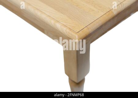 View of the corner of a wooden modern kitchen table. Kitchen dining table isolated on white background. Stock Photo