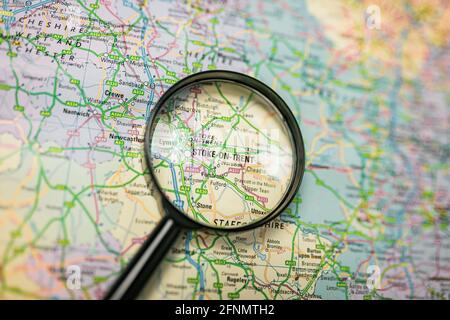 Close-up map of Stoke-on-Trent through black magnifying glass, city in England, United Kingdom Stock Photo