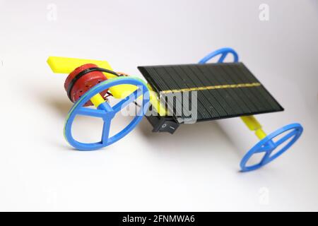 Solar panel powered vehicle called as solar powered car on white background. Green energy and future energy concept Stock Photo