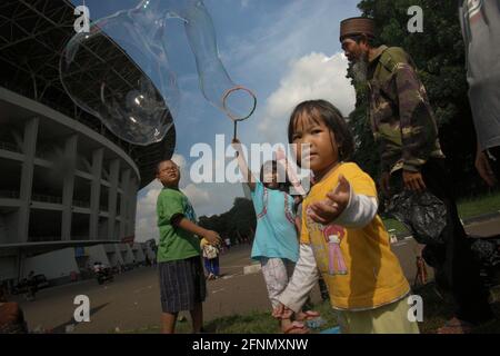 children playing with bubbles in the playground Stock Photo - Alamy