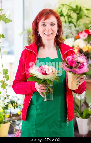 Florist selling flowers and bouquets in shop Stock Photo
