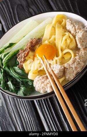 Ban Mian Minced Pork Noodle Soup Handmade closeup in the bowl on the table. Vertical Stock Photo