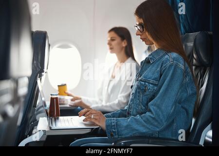 Woman working with laptop on the plane Stock Photo