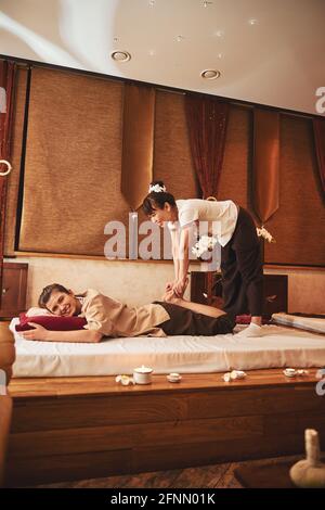 Worker of spa centre and client during feet massage Stock Photo
