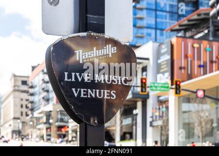 A sign shaped like a guitar pick advertising the live music venues in downtown Nashville. Stock Photo