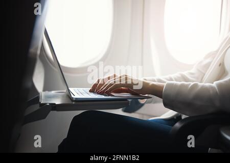 Using the flight time productively and working Stock Photo
