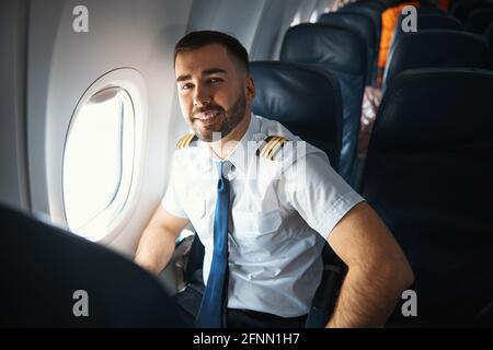 Satisfied pilot after checking the airplane cabin Stock Photo