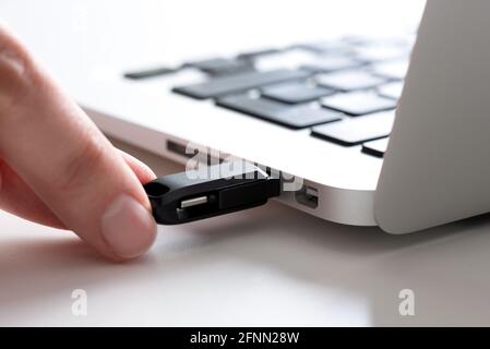 Hand connecting USB flash drive. Pendrive, flash memory concept Stock Photo