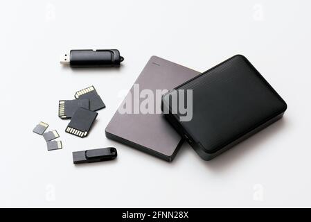 Multiple storage devices, pendrive, memory cards, external USB disks, isolated Stock Photo