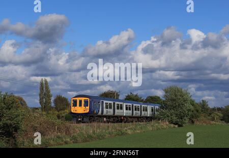 Northern’s “new” flexi unit trains entered revenue earning service on 17th May 2021, this one travels through the countryside near Burscough Stock Photo
