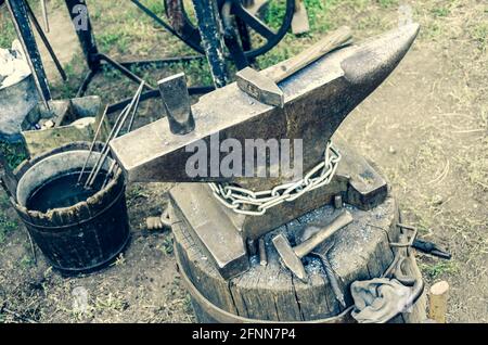 Old anvil with blacksmith tools Stock Photo