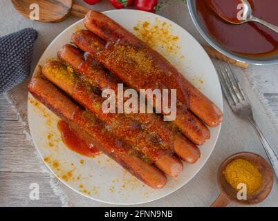 fried sausages with delicious fruity tomato curry sauce Stock Photo